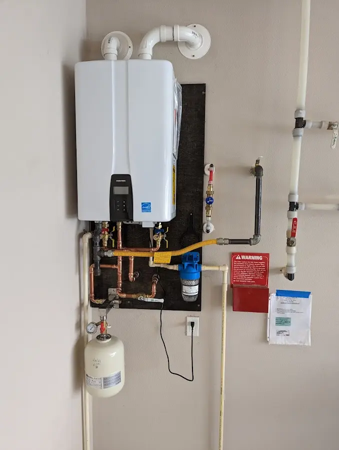 Professional plumber installing copper piping in a Westwood Lakes home